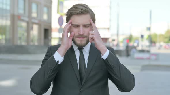 Portrait of Businessman Having Headache Outdoor