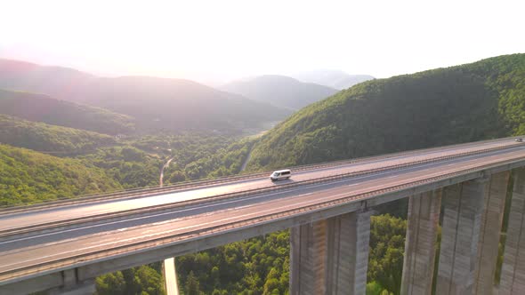 Aerial View of Cars Speeding on Highway Mountain Bridge in Hot Summer Morning