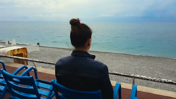 Woman Sitting on Empty Beach Seaside, Relaxing on Vacation, Loneliness, Sadness