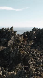 Hiker walking on ridge of Puebla de la Sierra mountains, Spain