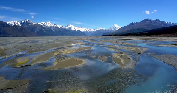 Epic aerial push-in over the Tasman River towards Mt Cook, New Zealand's highest peak. Low-level aer