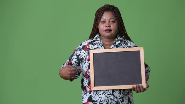 Overweight Beautiful African Woman Against Green Background