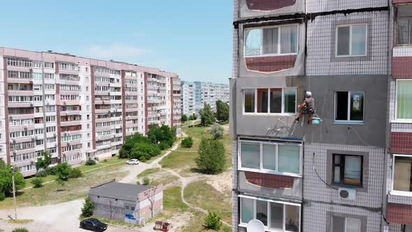 Aerial View Industrial Climber Perform Work on Insulation Side Facade Building