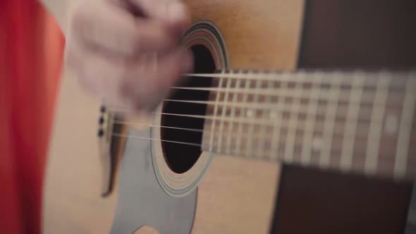 Closeup of a Man's Hands Playing the Guitar