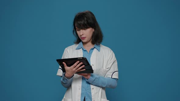 Research Scientist Using Digital Tablet to Browse Internet alt