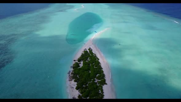 Aerial above scenery of exotic coastline beach vacation by shallow water with bright sandy backgroun