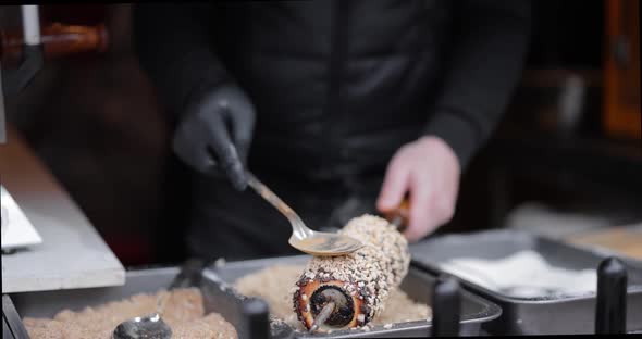 Preparing Trdelnik a Traditional Chech Street Food