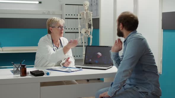 Health Specialist Showing Coronavirus Illustration on Laptop