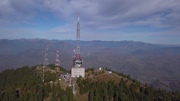 Heniu Summit, Romania - Telecommunication On The Lush Mountain Peak With Gorgeous Mountains In The B