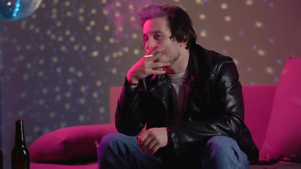 Relaxed Male Smoking Cigarette, Chilling Out at Private Disco Party, Leisure