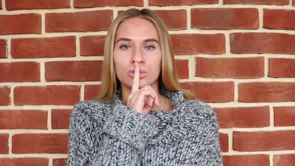 Gesture of Silence By Woman Finger on Lips