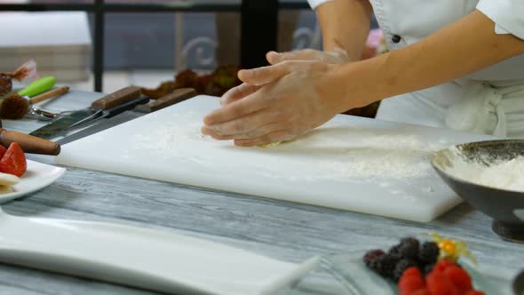 Man's Hands Roll Out Dough.