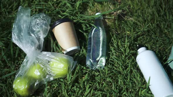 Reusable Water Bottles Fresh Apples and Cup Lie on Green Grass Outdoors on Summer Day Spbd