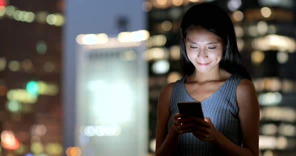Woman use of smart phone in the evening 