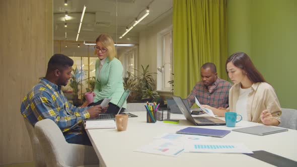 Female Executive Helping Team with Working Tasks