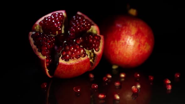 Two Fruit Grenades Lie on a Black Table on a Black Background