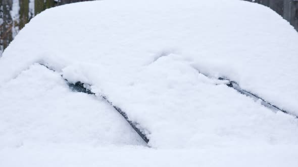 Cleaning the Windshield of the Car From Snow with Wipers