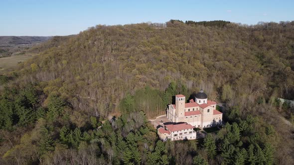 Beautiful sunny fall day. View of cathedral tucked into forest on mountain side.