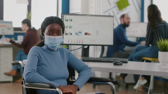 Handicapped African Employee Looking at Camera Wearing Protection Mask