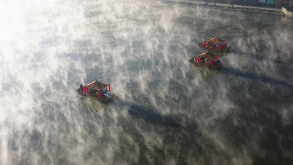 Aerial View of Sunrise with Fog Over Ban Rak Thai Chinese Village Near a Lake in Mae Hong Son