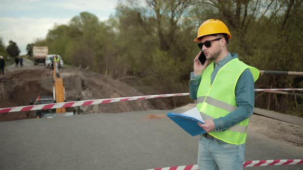 Portrait of Young Man Working Speaking By Phone