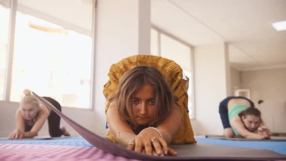 Three Women Do Yoga in the Studio