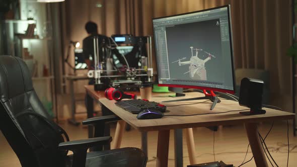 Personal Computer And 3D Printer, Screen Shows Cad Software With 3D Prototype Of Drone Delivery