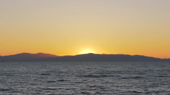 Amazing Colorful Sunset Over Sea and Mountain Chain