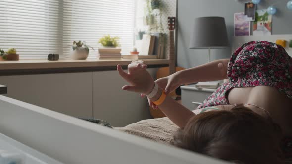 Girl Looking at Hospital Tag