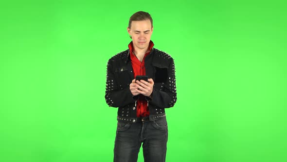 Guy Texting on His Phone, Green Screen