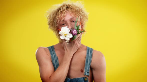 Handsome Androgynous Man Putting Hands on Neck Imitating Choking and Taking Off Flower Mask in Slow