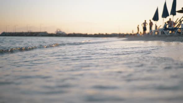 Sea Waves Washing the Shore of Resort at Sunset