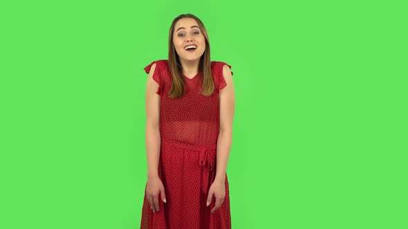 Tender Girl in Red Dress Is Saying Wow with Shocked Facial Expression. Green Screen
