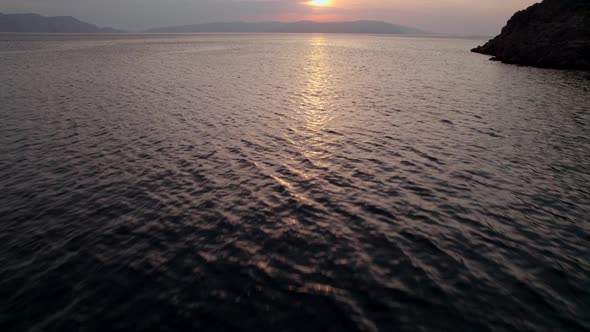 Fast Drone Flight Above the Sea Water at Sunset