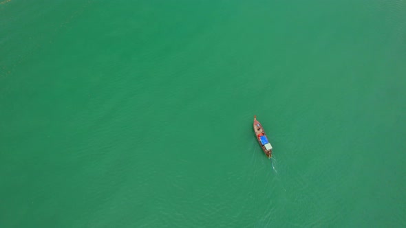 Aerial view of a ship sailing in the sea. Trang, Thailand. Cinematic drone shot. 4K