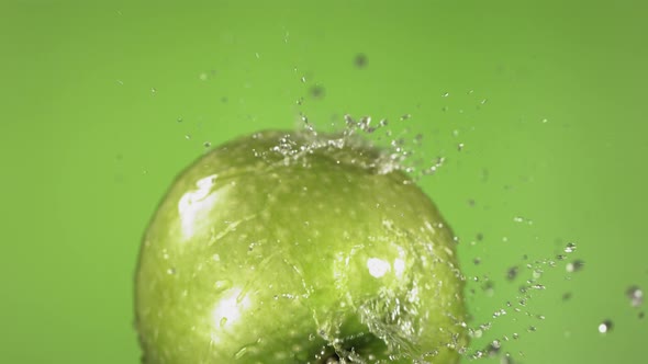 Flying of Green Apple in Green Background in Slow Motion