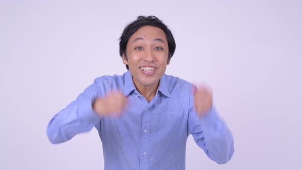 Happy Japanese Businessman Looking Excited with Fists Raised