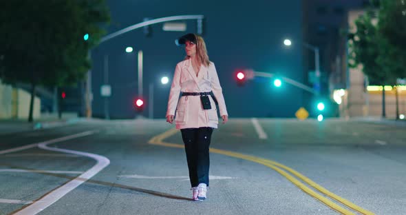 Stylish Woman in Trendy Futuristic Cosmic Clothes Walking By Empty Night City