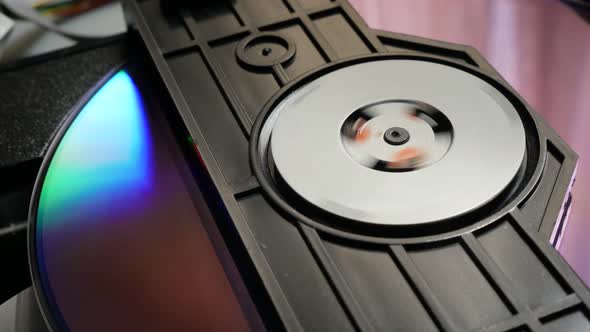 Rotating compact disk  in the reading mechanism close-up 4K 3840X2160 30fps UHD video - DVD or CD in