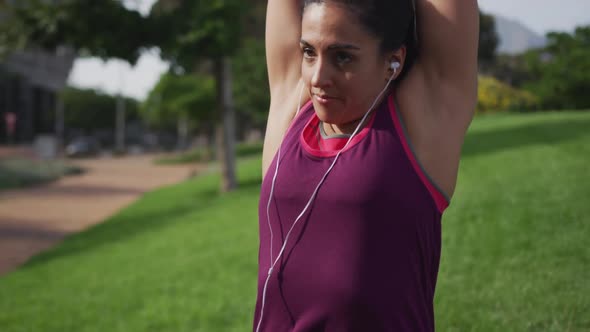 Caucasian woman stretching in a park