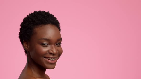 Happy Black Young Woman With Short Haircut Over Pink Background