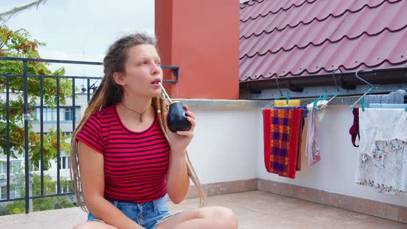 Young Woman Drinks Argentine Mate Tea at Home