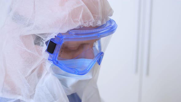 Closeup of a Doctor's Face in Goggles and a Mask