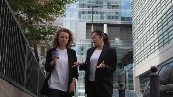 Conversation of Two Business Women Outside Office Buildings