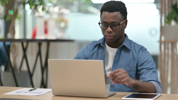 Young African Man Closing Laptop Standing Up Going Away