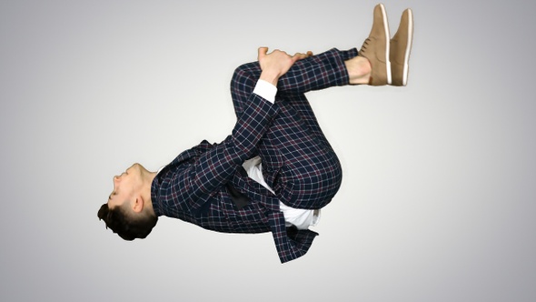Businessman makes a back flip and shows cool gesture to