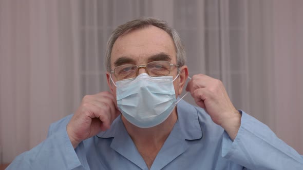 Close Up Portrait Elderly Man Takes Off a Medical Mask His Face