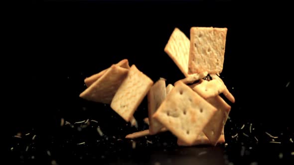 Super Slow Motion Cracker with Rosemary Falls on the Table