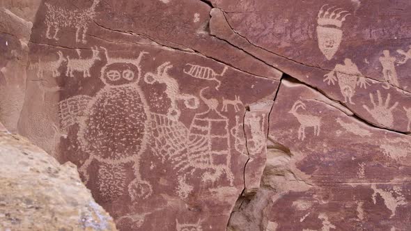 Panning across big petroglyph panel with bear paw