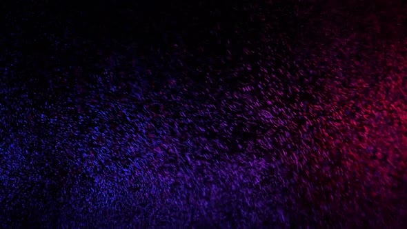 Red and Blue Water Spray Mixed on a Black Background. Slow Motion alt